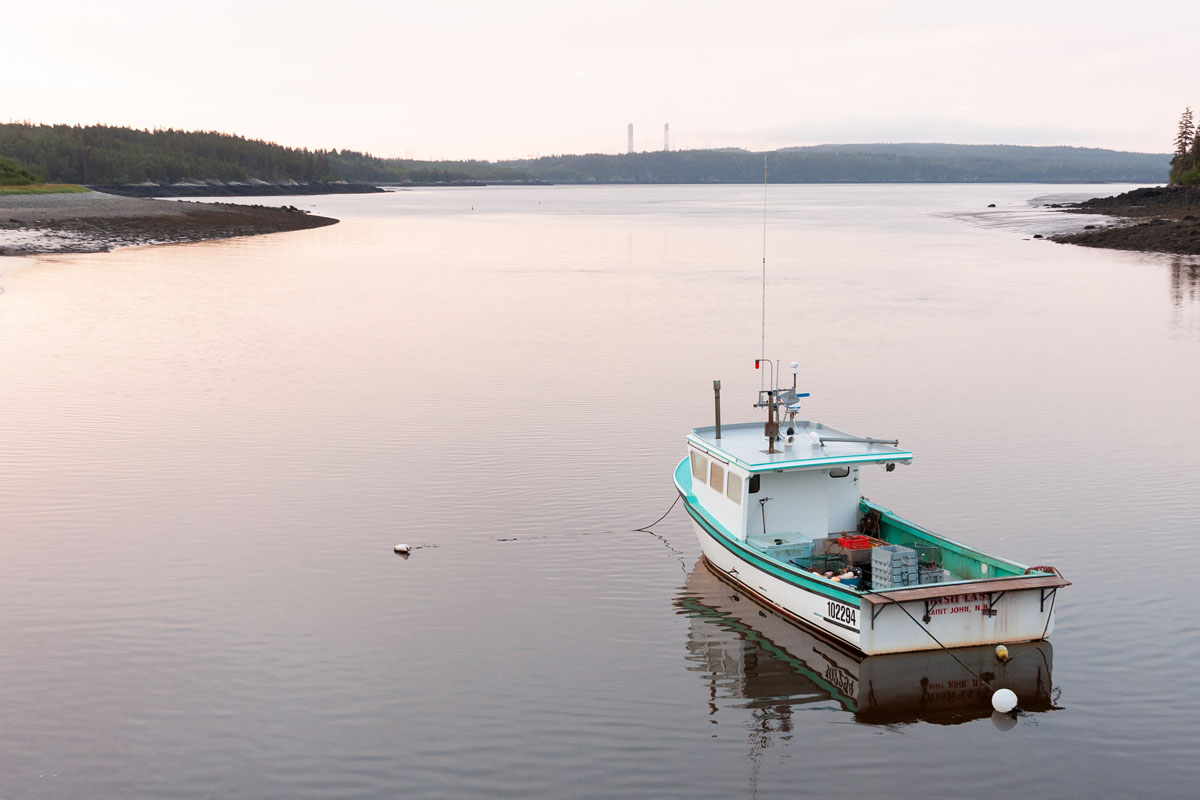 A lobster fishing boat tied up in the Musquash River at Five Fathom Hole, New Brunswick, shortly after sunrise.